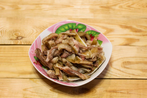 istock Boiled fragrant pork ears in plates on a wooden table 1130710408