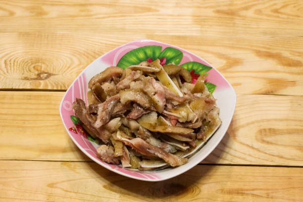 istock Boiled fragrant pork ears in plates on a wooden table 1130710412
