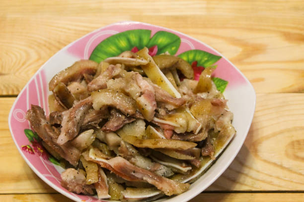 istock Boiled fragrant pork ears in plates on a wooden table 1130710413