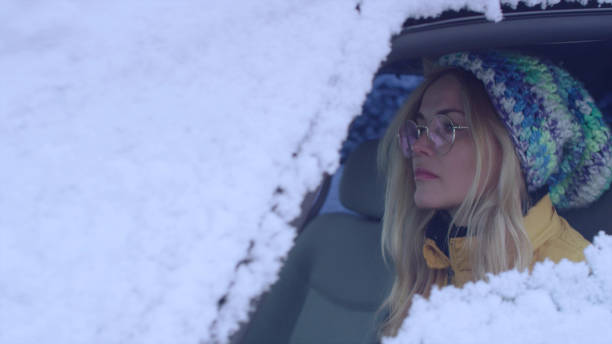 istock Female driver enjoying snow covered world 1130711359