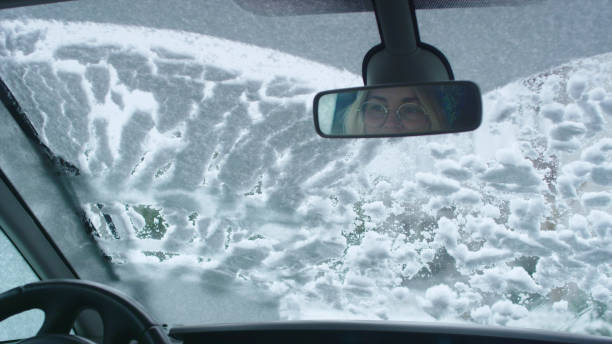 istock Driver's POV. Car wipers cleaning snow on window 1130711412