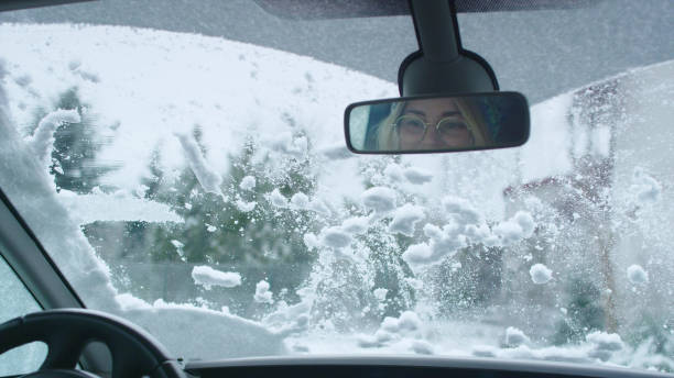 istock Driver's POV. Car wipers cleaning snow on window 1130711413