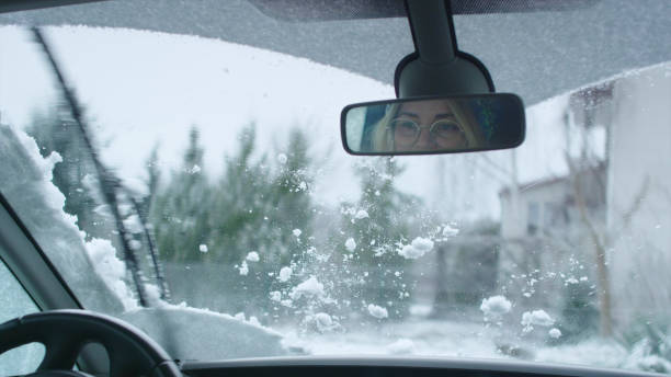 istock Driver's POV. Car wipers cleaning snow on window 1130711420