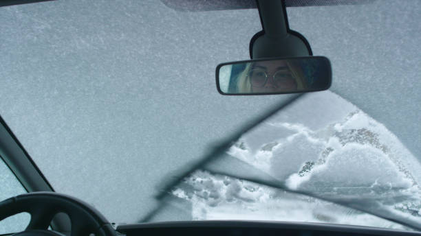 istock Driver's POV. Car wipers cleaning snow on window 1130711421