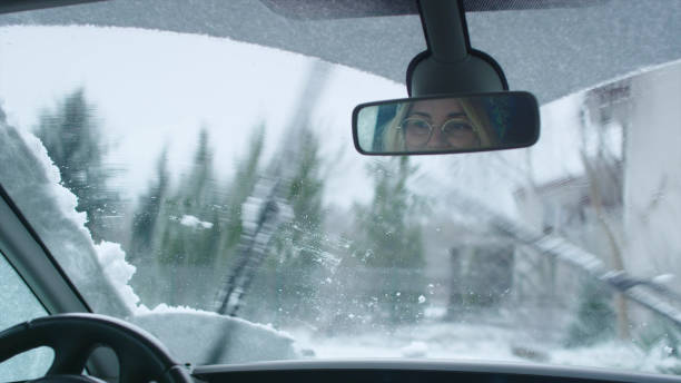 istock Driver's POV. Car wipers cleaning snow on window 1130711426