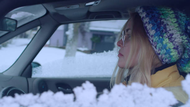 istock Female driver enjoying snow covered world 1130711436
