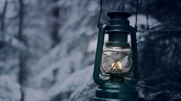 istock Walking in forest with lantern. Winter wonderland 1130711475