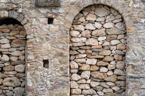 istock ancient stone wall with an arch in a niche 1130711977