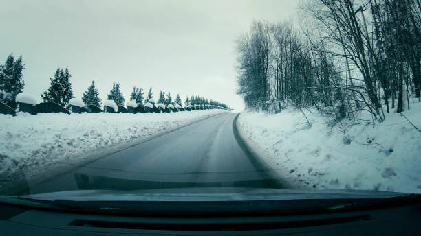 istock On the road. Driver's POV, looking at snow covered world 1130714962