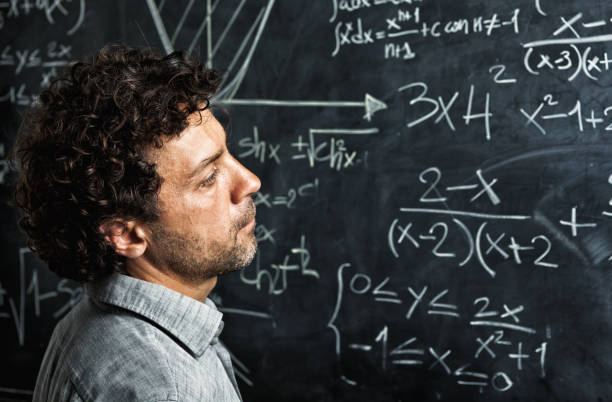 istock Teacher Looking At Blackboard In Classroom 1130715158