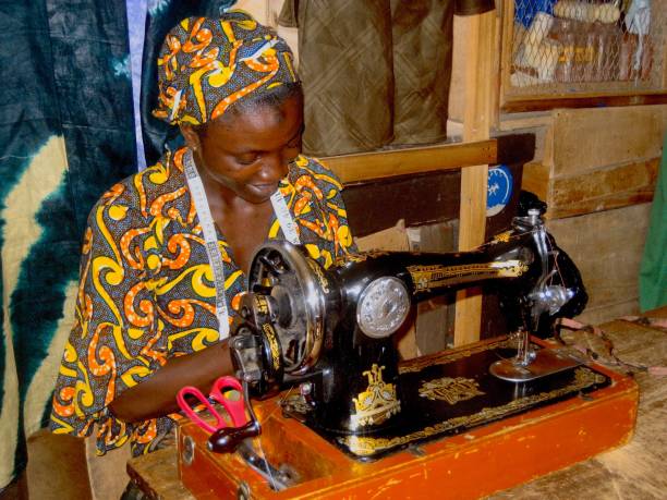 istock Tailor With Tap Measure Sitting By Sewing Machine 1130715766