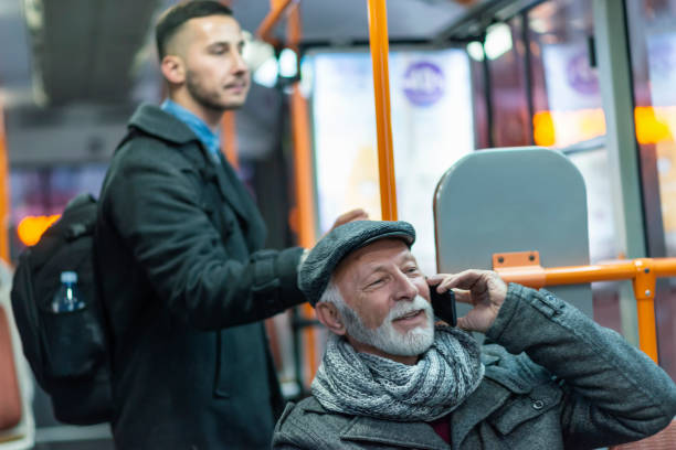 mature man riding in a bus - bus riding public transportation businessman imagens e fotografias de stock