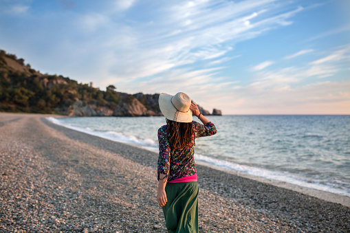 Young woman walking on the beach, Cala del Cañuelo, Andalusia, Spain