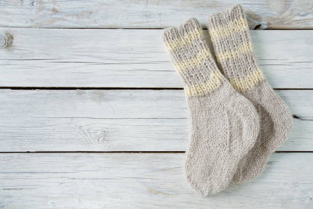 istock knitted grey socks on wooden surface 1130717588