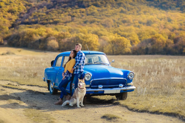 istock Couple with dog having fun with hay stack on wheat field on warm summer evening. 1130721114