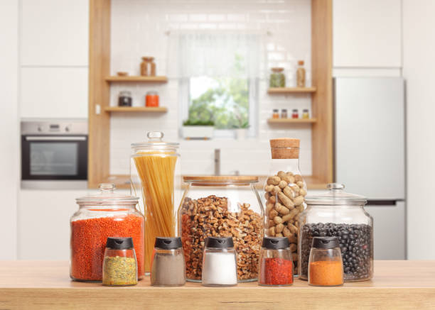 Many Glass Jars With Different Ingredients And Spices On A Kitchen Worktop  Stock Photo - Download Image Now - iStock