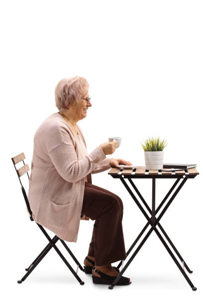 istock Senior woman drinking coffee at a table 1130722368