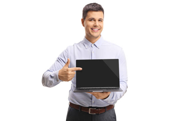 istock Young man holding a laptop computer and pointing to the screen 1130722732