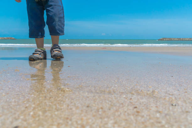 istock Child walking on the beach 1130722853