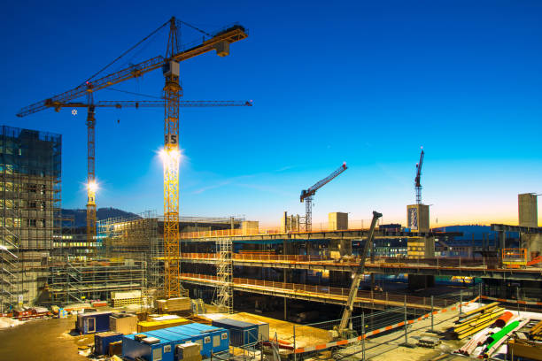 Construction site at dusk Construction site with artificial light and spotlights at dusk tungsten image stock pictures, royalty-free photos & images