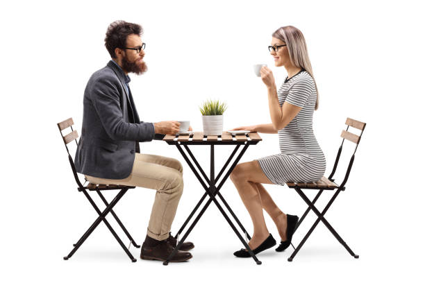 istock Young man and woman drinking coffee at a table 1130724648