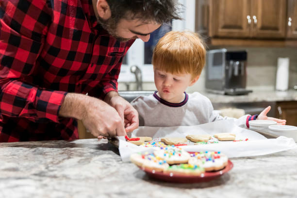 istock Father and Son Baking and Decorating Cookies 1130727354