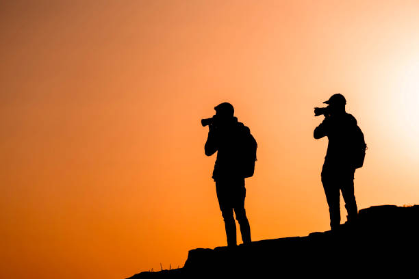 istock Photographers who shoots a sunset in the mountains 1130729282