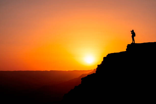 istock Photographer who shoots a sunset in the mountains 1130729283