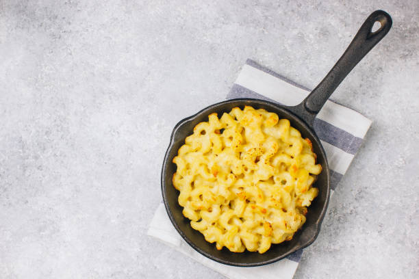 istock Mac and cheese, american style macaroni pasta with cheesy sauce 1130729524