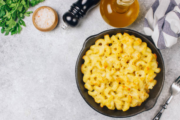 istock Mac and cheese, american style macaroni pasta with cheesy sauce 1130729528