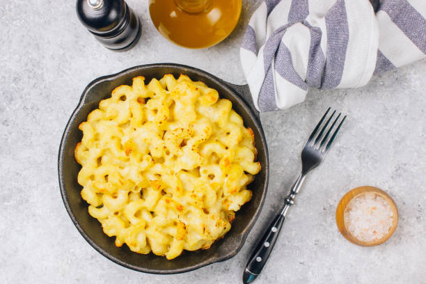 istock Mac and cheese, american style macaroni pasta with cheesy sauce 1130729532