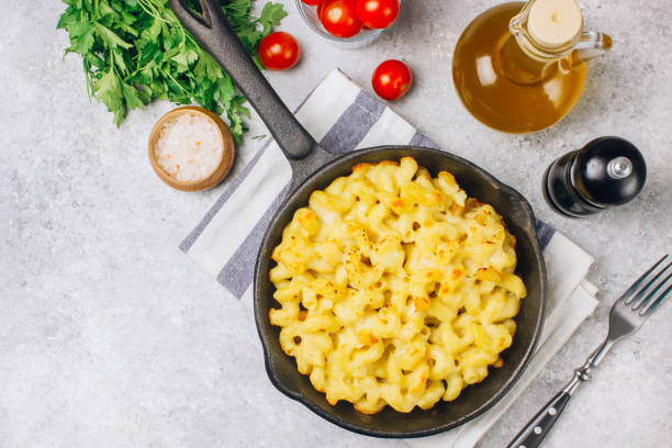 istock Mac and cheese, american style macaroni pasta with cheesy sauce 1130729534