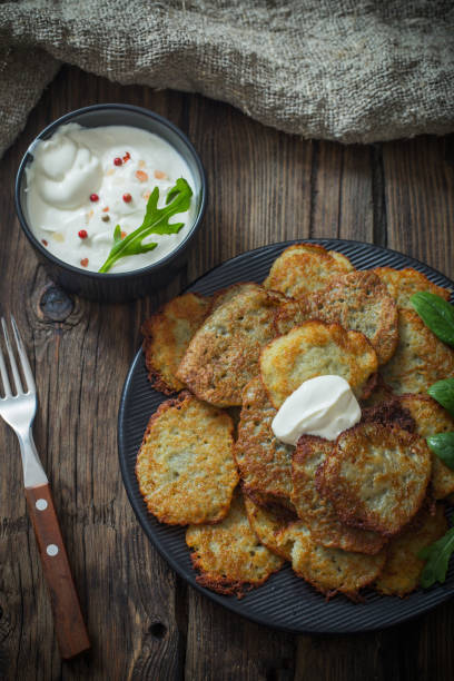 istock potato pancakes with sour cream on  wooden table 1130729862