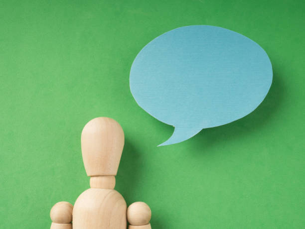 istock Communication-Wooden figure doll with speech bubble. 1130731335