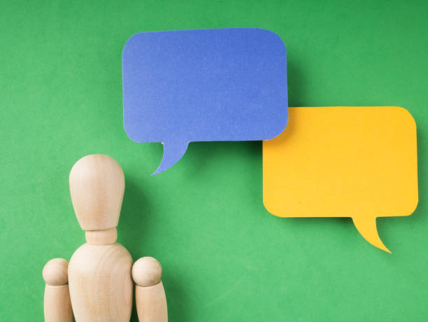 istock Communication-Wooden figure doll with speech bubble. 1130731447