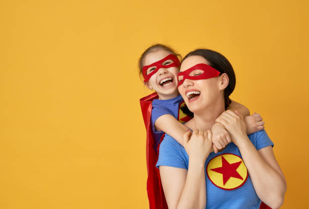 girl and mom in superhero costume - clothing love family with one child parent imagens e fotografias de stock