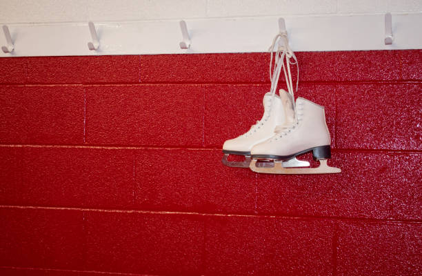 istock Figure skates hanging over red wall in locker room with copy 1130732814