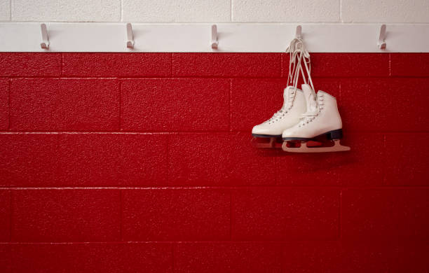 istock Figure skates hanging over red wall in locker room with copy 1130732987