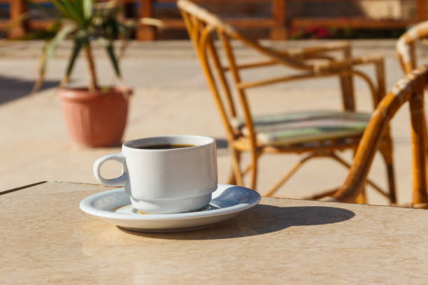 istock Cup of coffee on a table in cozy outdoor cafe 1130734598