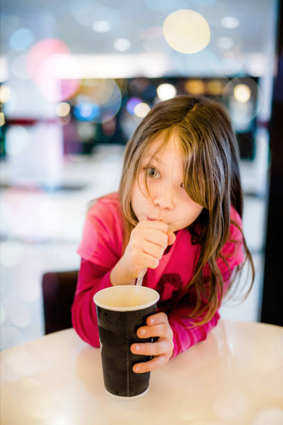 istock Beautiful child drinking a fresh drink 1130735238