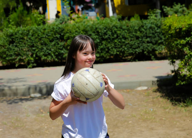 Little girl have fun with a ball