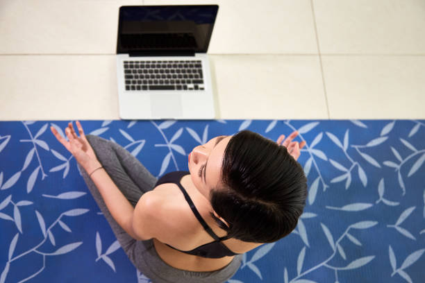 istock Woman teaching yoga online 1130737675