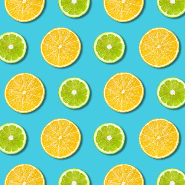istock Vibrant lemon and green lime slices texture on turquoise background 1130738115