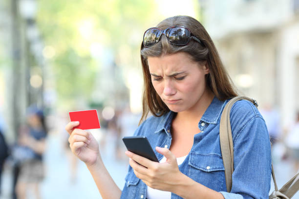 istock Worried girl having problem paying online with credit card 1130738165