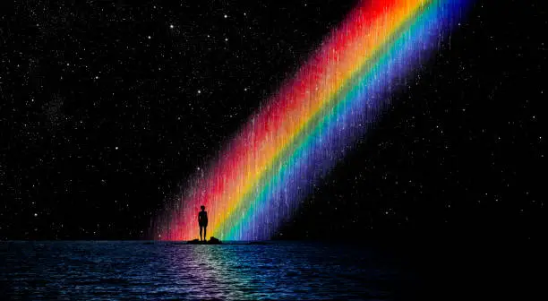 Woman standing before a rainbow