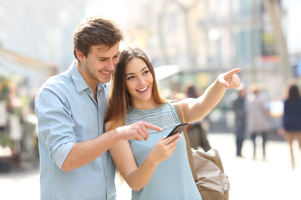 istock Friends or couple checking location on phone 1130738955