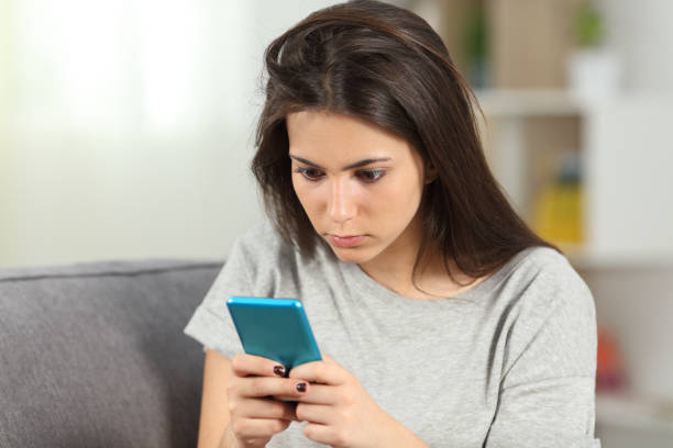 istock Addicted teen checking smart phone content at home 1130738992