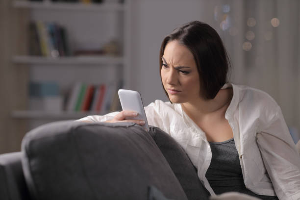 istock Suspicious woman checking phone content in the night 1130739183