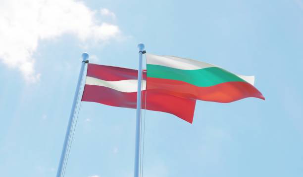 istock Latvia and Bulgaria, two flags waving against blue sky 1130739762