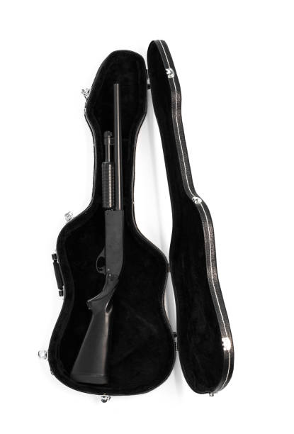 istock shotgun in a guitar case 1130745826